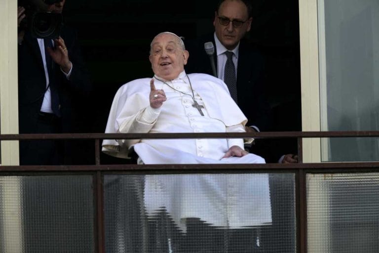 Pope Francis gestures as he appears at a window of the Agostino Gemelli hospital