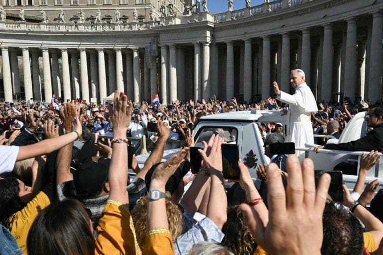 Pope Leo XIV waves as he arrives for the celebration of his inauguration mass