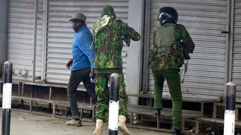 photo showing police officer aiming and shooting the city vendor